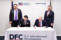 (Left to right) Bob Stebbins, Vice President and General Counsel for DFC, Conor Coleman, Head of Investments at the U.S. International Development Finance Corporation (DFC, Sir Mick Davis (seated) Cha